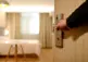 A hand opening a hotel room door